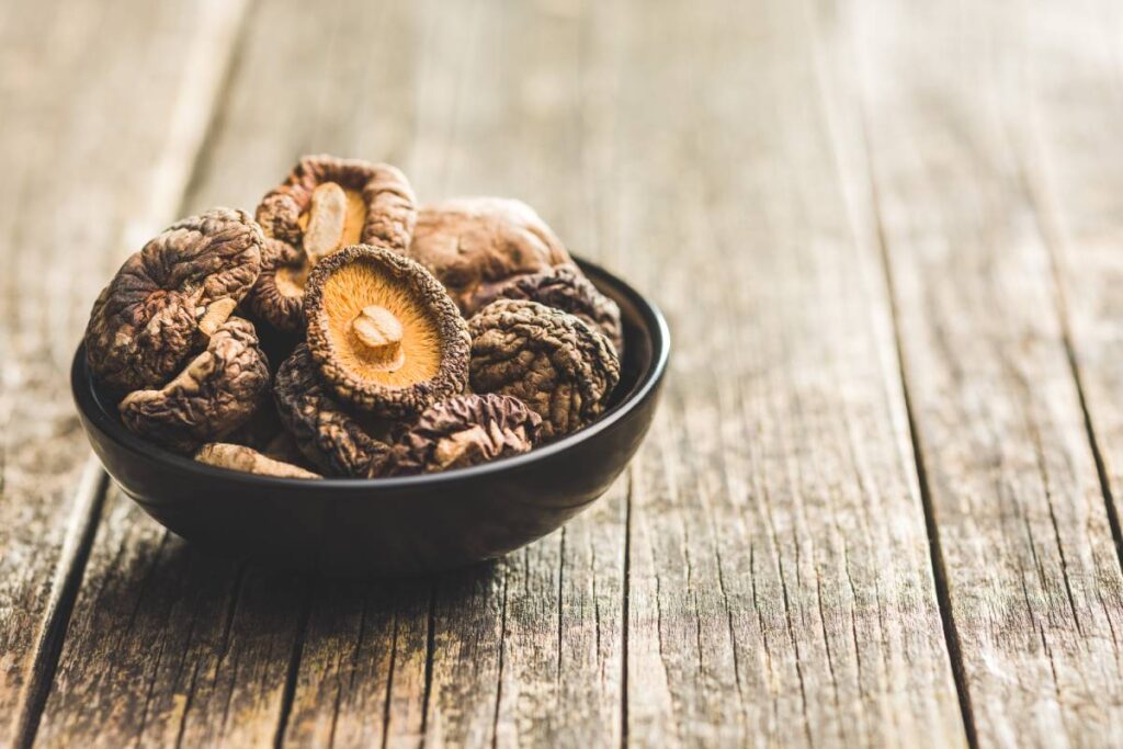 Dried shiitake mushrooms in bowl on the kitchen table.