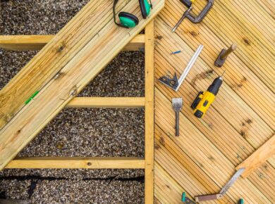 Top down image of a desk under construction showing joists, planks and tools used